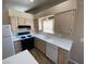 Bright kitchen features laminate floors, white appliances, and ample counter space for food preparation at 7564 Durham Hall Ave # 201, Las Vegas, NV 89130