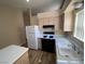 Bright kitchen with stainless steel appliances, laminate floors, and plentiful counter space at 7564 Durham Hall Ave # 201, Las Vegas, NV 89130