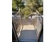 Spiral staircase with gray metal railing leads down to the backyard of the home at 7564 Durham Hall Ave # 201, Las Vegas, NV 89130