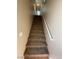 Carpeted staircase with white railing leads to the upper level at 7564 Durham Hall Ave # 201, Las Vegas, NV 89130