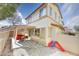 Charming backyard with a covered patio, gravel landscaping, and play area with a slide at 759 Sunrise Crossing St, Henderson, NV 89014