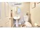 Cozy powder room with a pedestal sink, toilet, and neutral decor at 759 Sunrise Crossing St, Henderson, NV 89014