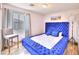 Inviting bedroom with a plush blue bed frame, neutral walls, and natural light at 759 Sunrise Crossing St, Henderson, NV 89014