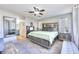 Open bedroom showcasing a large bed, ceiling fan, neutral walls, and an ensuite bathroom entrance at 759 Sunrise Crossing St, Henderson, NV 89014