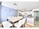 Bright dining area with an elegant table set and stainless steel appliances in the adjacent kitchen at 759 Sunrise Crossing St, Henderson, NV 89014