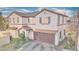 Stylish two-story home with a tile roof, archway, and attached garage, creating curb appeal at 759 Sunrise Crossing St, Henderson, NV 89014