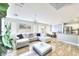 Open-concept living room with tile floors, a large sectional couch, and plenty of natural light at 759 Sunrise Crossing St, Henderson, NV 89014