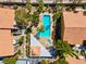 Aerial view of a sparkling community pool surrounded by lush landscaping and well-maintained apartment buildings at 7950 W Flamingo Rd # 1003, Las Vegas, NV 89147