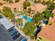 Aerial view of the community pool, jacuzzi, parking, clubhouse, and landscaping at 7950 W Flamingo Rd # 1003, Las Vegas, NV 89147