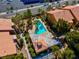 A high-angle perspective of the community pool, jacuzzi and surrounding residential buildings at 7950 W Flamingo Rd # 1003, Las Vegas, NV 89147