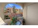 Balcony space with a table and chairs overlooking the building's exterior at 7950 W Flamingo Rd # 1003, Las Vegas, NV 89147