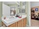 Bathroom featuring a double sink vanity with an open doorway leading into a bedroom space at 7950 W Flamingo Rd # 1003, Las Vegas, NV 89147