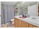 Well-lit bathroom featuring a double sink vanity and a shower-tub combination with modern fixtures at 7950 W Flamingo Rd # 1003, Las Vegas, NV 89147