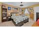 Cozy bedroom featuring a bed, side tables with lamps, and wooden flooring at 7950 W Flamingo Rd # 1003, Las Vegas, NV 89147