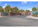 A gated community with brick signage, 'Rain Tree West', ensuring security and privacy at 7950 W Flamingo Rd # 1003, Las Vegas, NV 89147
