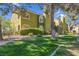 Charming two-story condo featuring an arched entryway, stucco walls, and lush green landscaping in a well-maintained community at 7950 W Flamingo Rd # 1003, Las Vegas, NV 89147