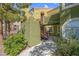 View of the stairway entrance to a green apartment building with lush foliage and walkway at 7950 W Flamingo Rd # 1003, Las Vegas, NV 89147