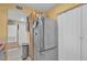 Kitchen area showcases stainless steel refrigerator with nearby closet and pantry storage at 7950 W Flamingo Rd # 1003, Las Vegas, NV 89147