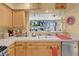 Kitchen sink with view to living room features cabinets, stainless steel dishwasher, and tiled flooring at 7950 W Flamingo Rd # 1003, Las Vegas, NV 89147