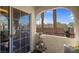 Cozy patio space with a view of trees, blue sky, and mountains in the distance at 7950 W Flamingo Rd # 1003, Las Vegas, NV 89147