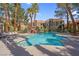 A beautiful community pool surrounded by lush landscaping and comfortable lounge seating at 7950 W Flamingo Rd # 1003, Las Vegas, NV 89147