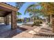 Backyard features a private pool, palm trees, and a covered patio area, great for outdoor living at 8209 Chapelle Ct, Las Vegas, NV 89131