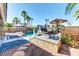 The home features a backyard pool and an outdoor seating area with mature trees for shade at 8209 Chapelle Ct, Las Vegas, NV 89131