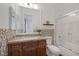 Cozy bathroom with granite countertops, wood cabinets, and a shower-tub combo at 8209 Chapelle Ct, Las Vegas, NV 89131
