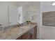 Bathroom vanity with granite counters, dual mirrors, and wood cabinets at 8209 Chapelle Ct, Las Vegas, NV 89131