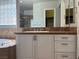 Bright bathroom featuring a white vanity with double sinks and a separate tiled bathtub at 8209 Chapelle Ct, Las Vegas, NV 89131