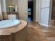 Elegant bathroom with a tiled soaking tub and spacious layout at 8209 Chapelle Ct, Las Vegas, NV 89131