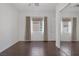 Bright bedroom with wood floors, large windows, and mirrored closet at 8209 Chapelle Ct, Las Vegas, NV 89131