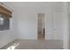 Bedroom with carpeted floors, white walls, and a peek into the bathroom at 8209 Chapelle Ct, Las Vegas, NV 89131
