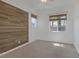 Bedroom with an accent wood wall, neutral carpet, and bright natural light at 8209 Chapelle Ct, Las Vegas, NV 89131