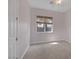 Neutral bedroom features a ceiling fan, window, and plush carpet at 8209 Chapelle Ct, Las Vegas, NV 89131