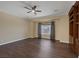 A bedroom with hardwood floors, built in shelving and a ceiling fan with natural lighting at 8209 Chapelle Ct, Las Vegas, NV 89131
