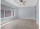 Bedroom features neutral walls and floors, a ceiling fan, and natural lighting at 8209 Chapelle Ct, Las Vegas, NV 89131