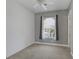 A bedroom with carpet, a ceiling fan, and a window with curtains at 8209 Chapelle Ct, Las Vegas, NV 89131