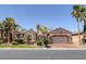 Stunning single-story home featuring lush landscaping, mature palm trees, stone accents, and a two-car garage at 8209 Chapelle Ct, Las Vegas, NV 89131