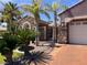 Charming single-story home with a stone facade, mature palm trees, and a well-manicured landscape at 8209 Chapelle Ct, Las Vegas, NV 89131
