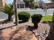 Landscaped front yard with palm trees, shrubs, decorative rock, and a 'For Sale' sign at 8209 Chapelle Ct, Las Vegas, NV 89131
