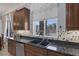 Kitchen area features granite countertops, tile backsplash, stainless steel appliances, and backyard pool view at 8209 Chapelle Ct, Las Vegas, NV 89131