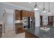 Kitchen features granite counters, stainless steel appliances, dark wood cabinets, and center island with breakfast bar at 8209 Chapelle Ct, Las Vegas, NV 89131