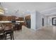 Open concept kitchen with dark wood cabinetry, granite counters, stainless appliances, and access to entryway at 8209 Chapelle Ct, Las Vegas, NV 89131