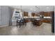 Eat-in kitchen boasts dark wood cabinetry, granite countertops, and a breakfast nook with backyard views at 8209 Chapelle Ct, Las Vegas, NV 89131