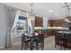 Kitchen with stainless steel appliances, granite countertops, dark wood cabinets, eat-in dining, and backyard views at 8209 Chapelle Ct, Las Vegas, NV 89131