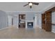 Bright and airy living room with a cozy fireplace, built in shelving and tile floors at 8209 Chapelle Ct, Las Vegas, NV 89131