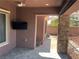 Covered outdoor patio featuring stone pillars and a mounted television at 8209 Chapelle Ct, Las Vegas, NV 89131