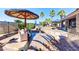 Beautiful backyard pool area with an umbrella-covered seating area, perfect for outdoor relaxation and entertaining at 8209 Chapelle Ct, Las Vegas, NV 89131