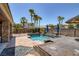 Stunning backyard pool and spa area with mature palm trees and comfortable lounge seating at 8209 Chapelle Ct, Las Vegas, NV 89131